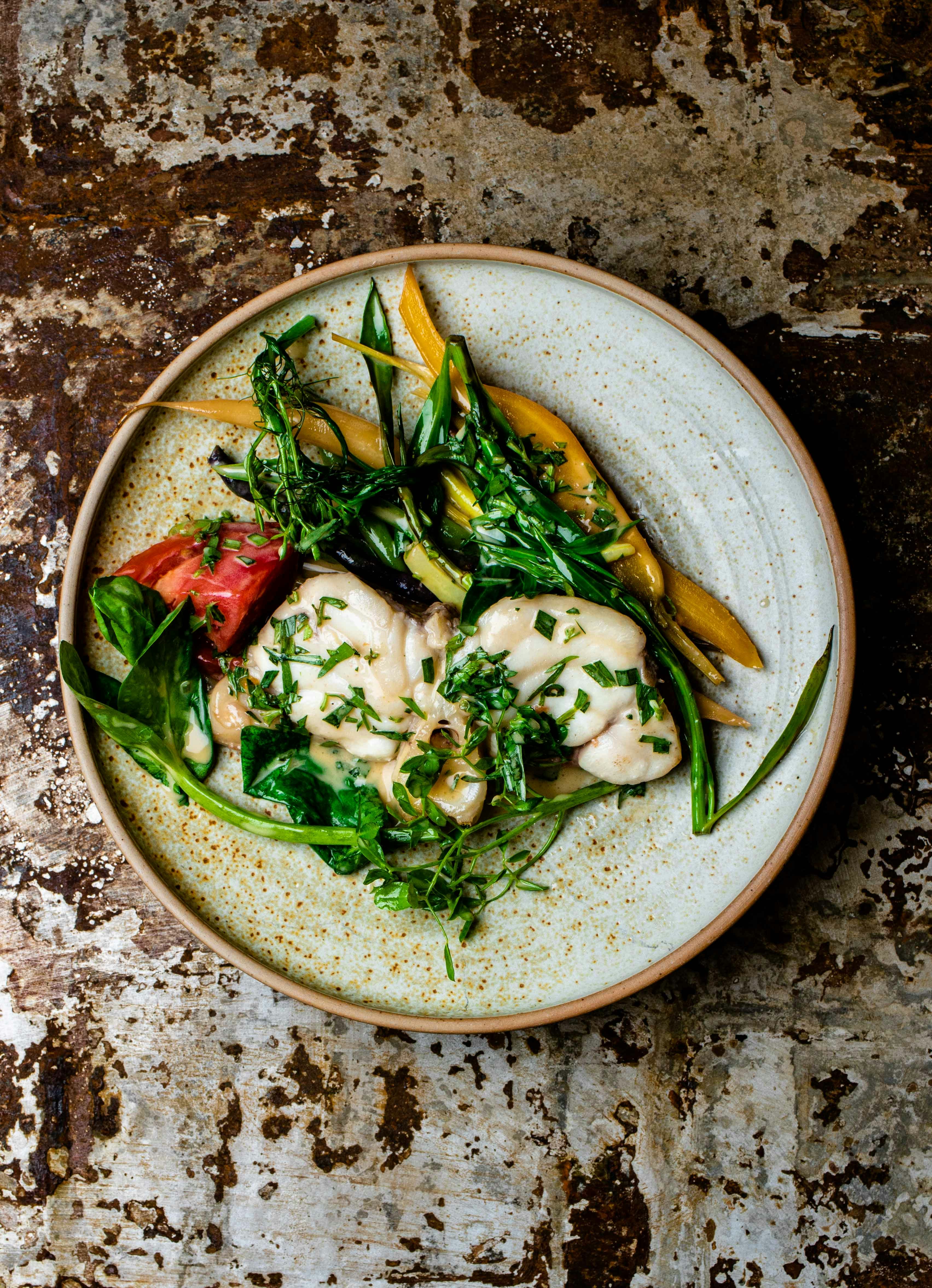 green and white vegetable salad on blue and white ceramic bowl